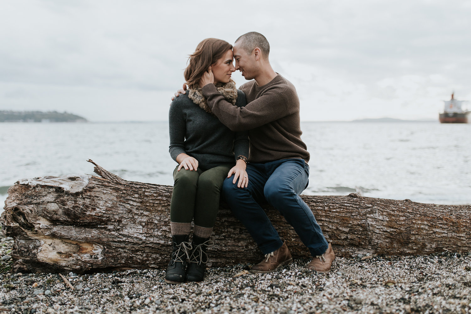 Gorgeous couple on a Seattle beach at sunset with overcast skies.